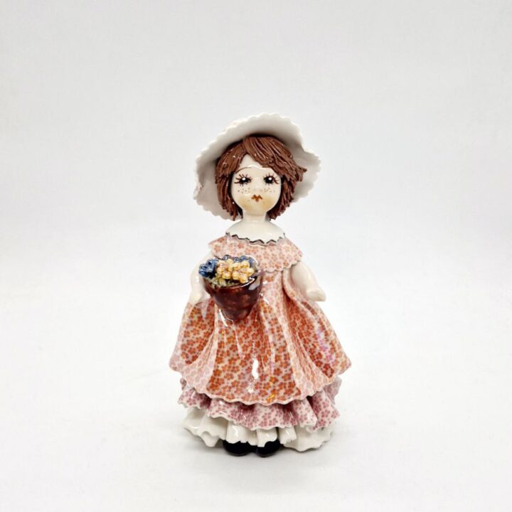 Doll with grapes