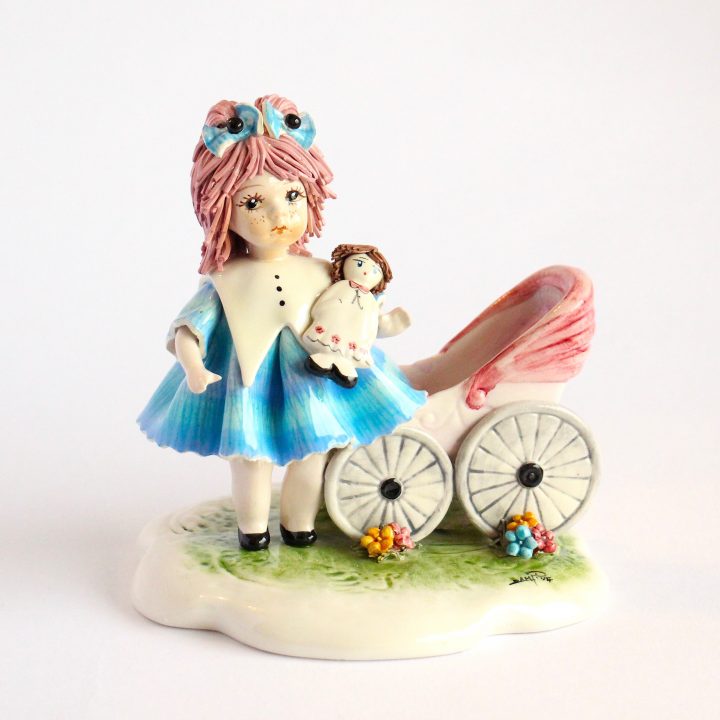 Doll with baby and a carriage