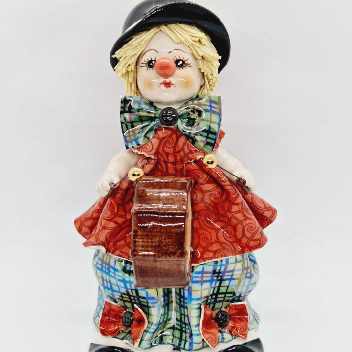 Clown musician on drum